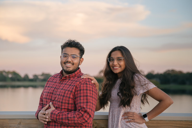 Brother and sister leaning against pier rail, golden hour, Bradenton, Florida, lifestyle family photography