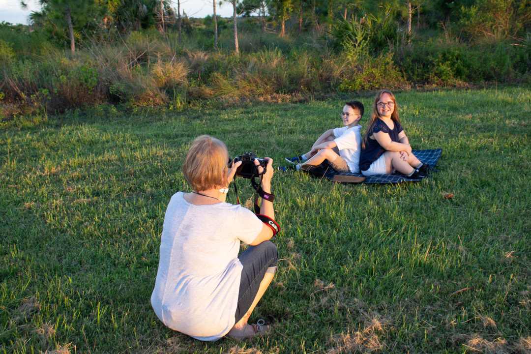 Behind the Scenes, photo shoot, outdoors, brother and sister sitting on ground
