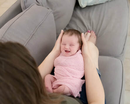 Baby smiling in mother's lap