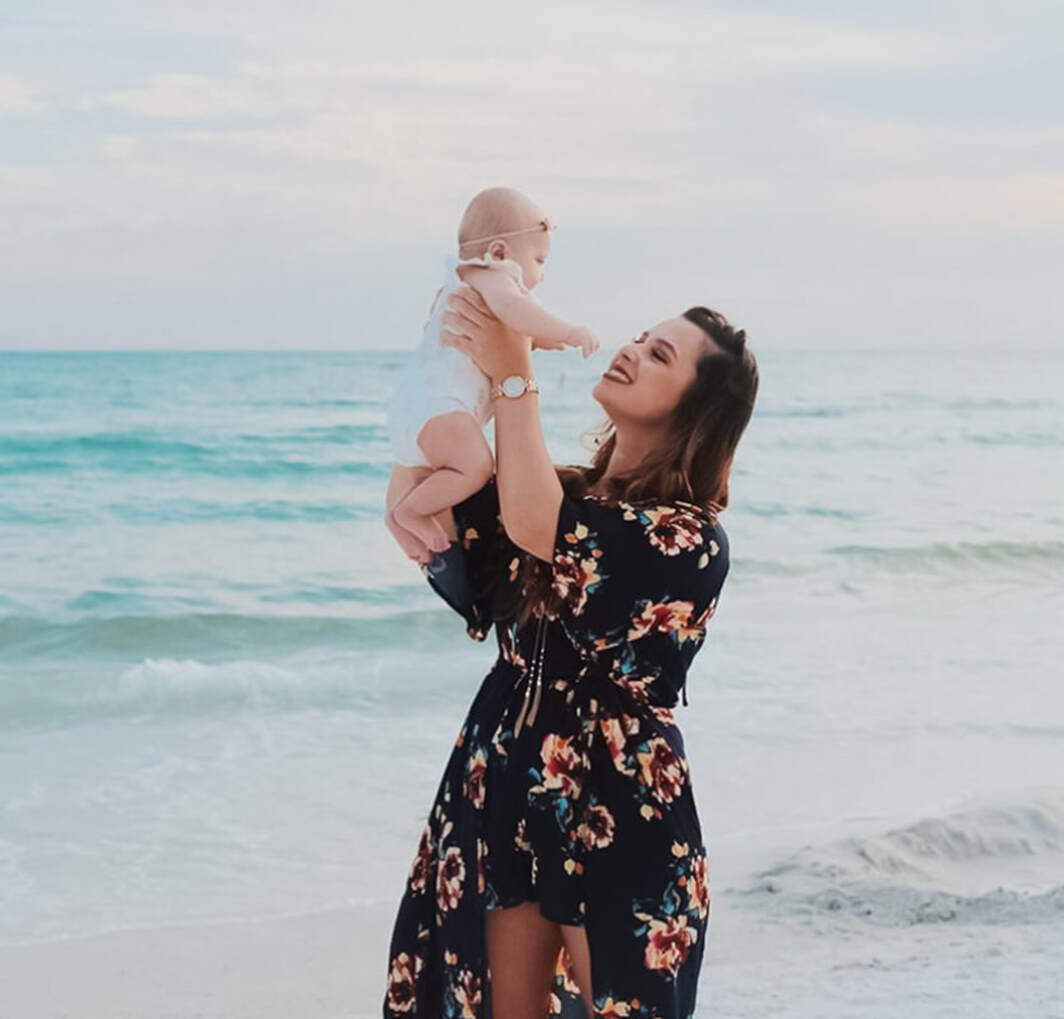 Mom holding up baby, golden hour, Siesta Key Beach, Florida