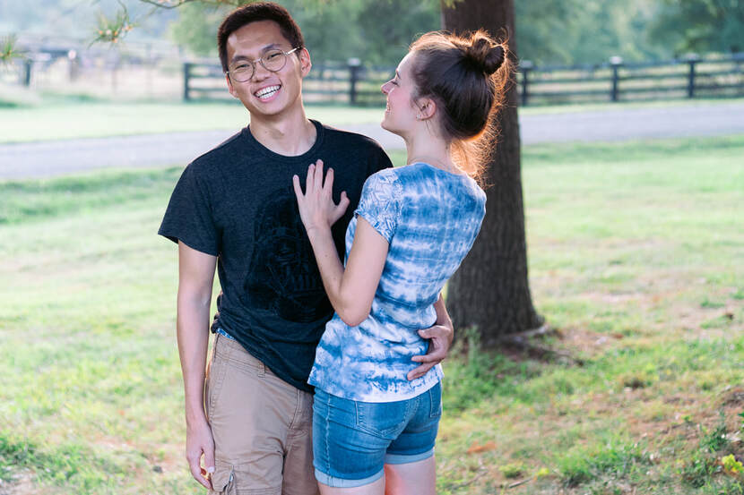 Young couple laughing outside