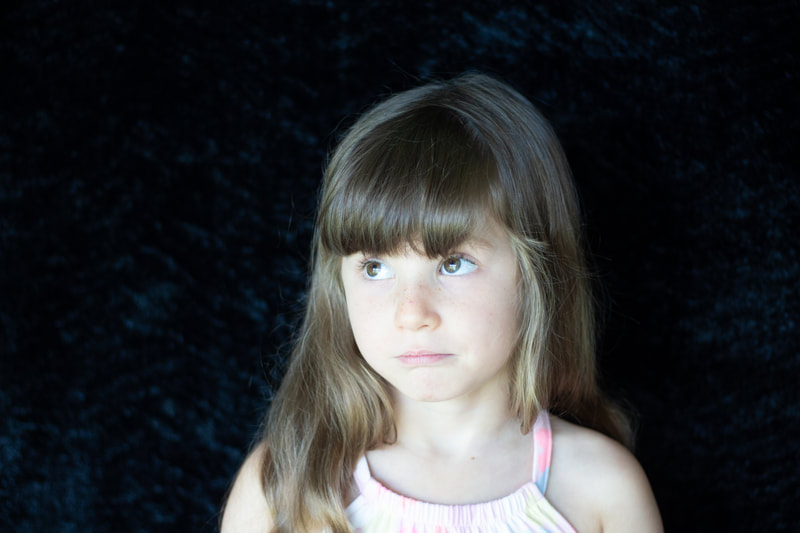 Little girl with eyes looking up, school photography