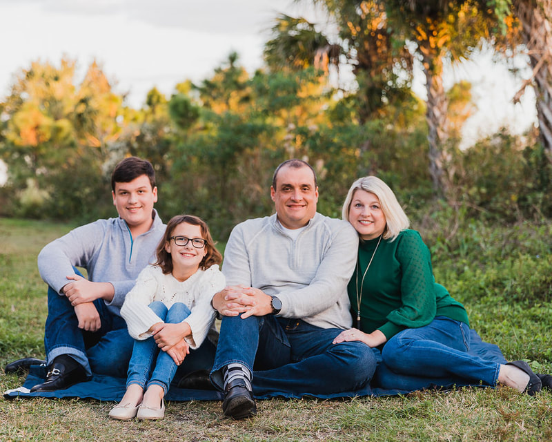 Family of four sitting on ground, golden hour, Celery Fields, Sarasota, Florida