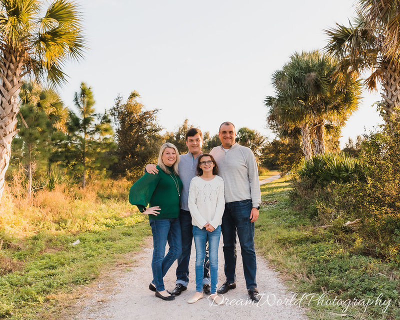 Family of four standing on gravel path, golden hour, Celery Fields, Sarasota, Florida