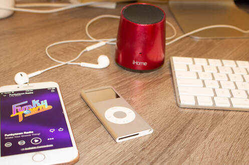 iPhone, iPod, iHome bluetooth speaker on desk