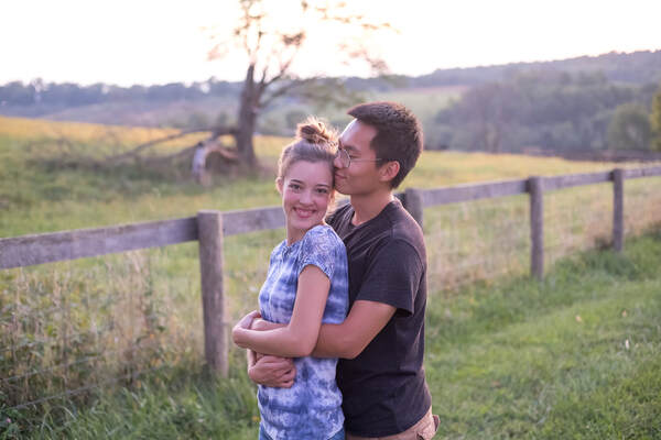 Man with woman's back to him hugging and smiling on farm in The Plains, VA