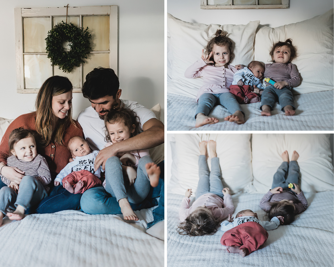 Mom and dad tickling toddlers while holding newborn, toddlers on bed with newborn baby brother