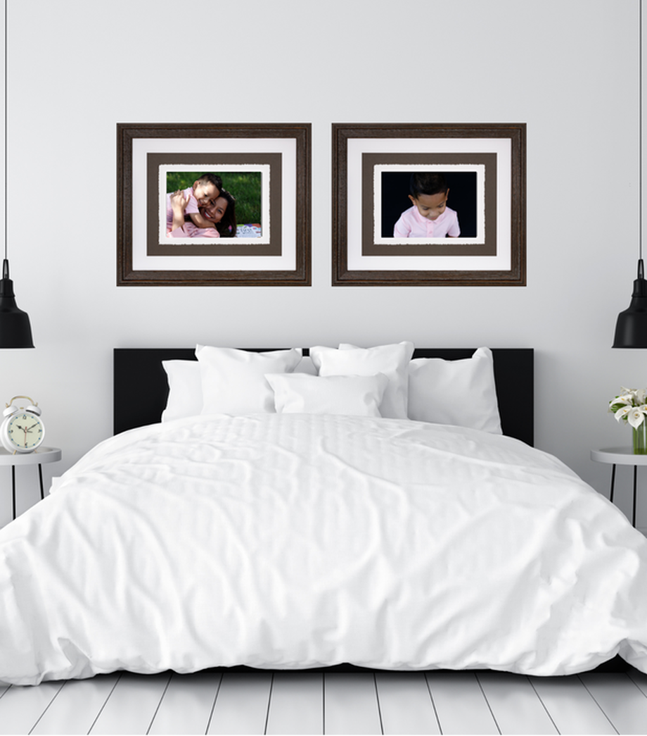 Bedroom with two framed photos above bed